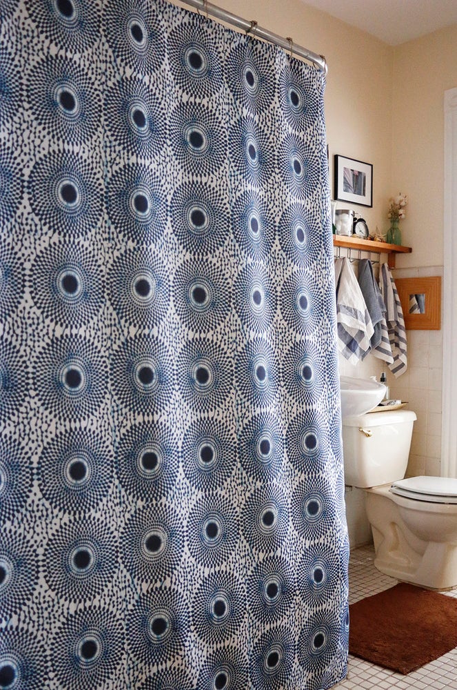 African wax print shower curtain in black and white, modern bathroom. Global homes and eclectic interior design in Brooklyn, Washington, DC, San Francisco.