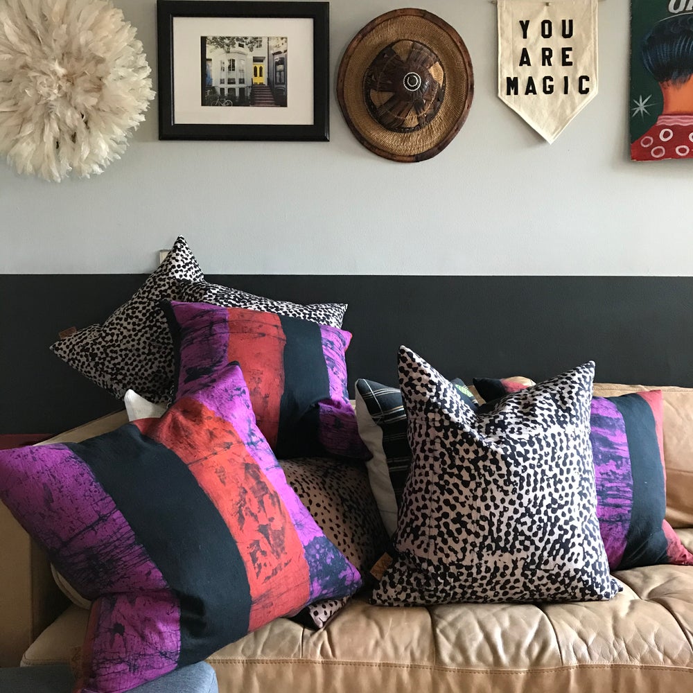 Fair Trade batik textile home goods for modern Boho home, pillows made in Ghana in partership with Osei-Duro. African home decor and textiles in modern home with African art and juju hat.