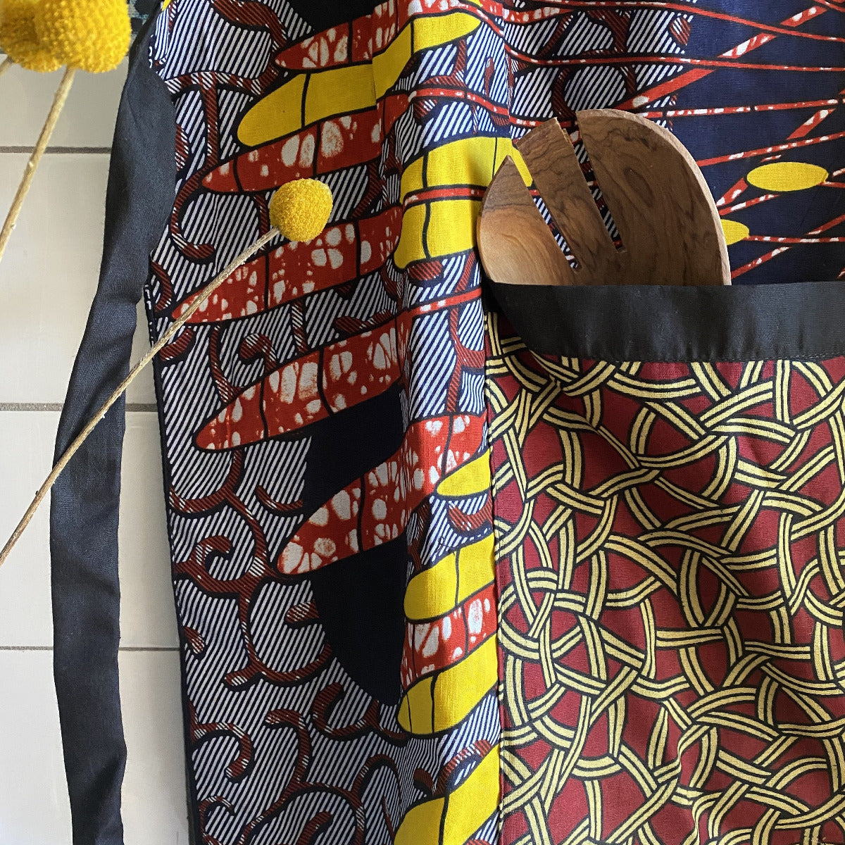 Handcrafted African wax print apron made in Uganda. Perfect for housewarming and wedding gitfs. Excellent for entertaining guests during the holidays, Thankgiving, Christmas, and more.