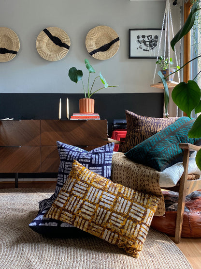 Batik and mudcloth textile home goods in modern Boho home, pillows made in Tanzania. African art.