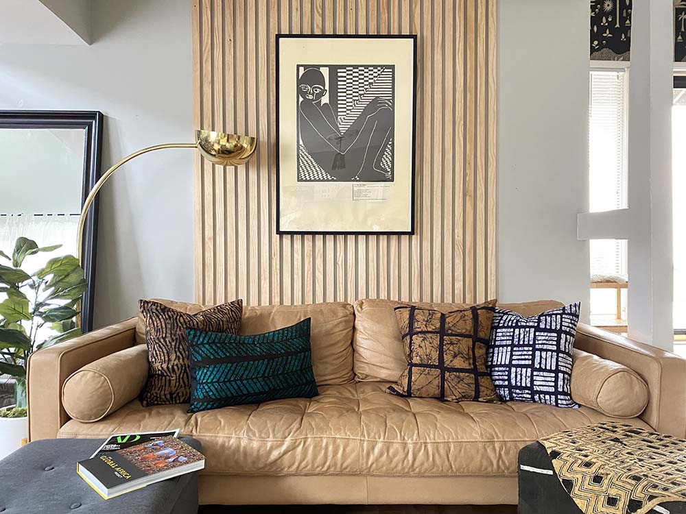 Batik and mudcloth textile home goods in modern Boho home, pillows made in Tanzania. African art.