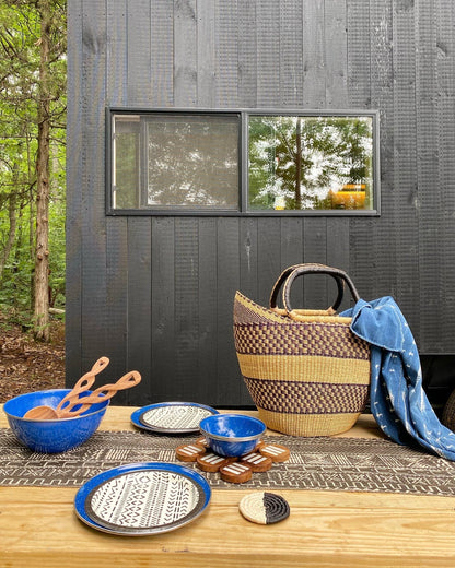 Pot holder. Fair Trade home goods and table top trivet, made in Uganda from acacia wood and cowhorn. Perfect for housewarmings and wedding gifts. Seen here with mudcloth table runner and acacia wood salad servers..